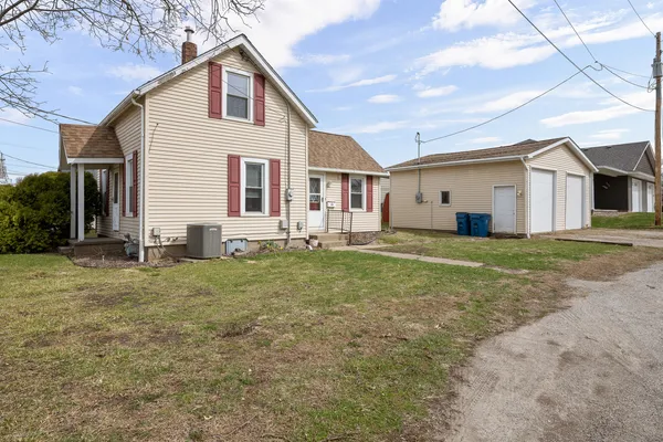 a view of a yard in front view of a house