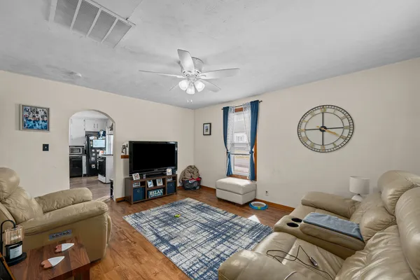 a living room with furniture a flat screen tv and a fireplace
