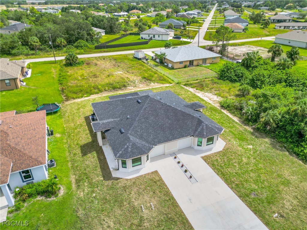 2508-2510 Park Road Lehigh Acres, FL 33971 - Photo 4 of 37 an aerial view of residential houses with outdoor space and street