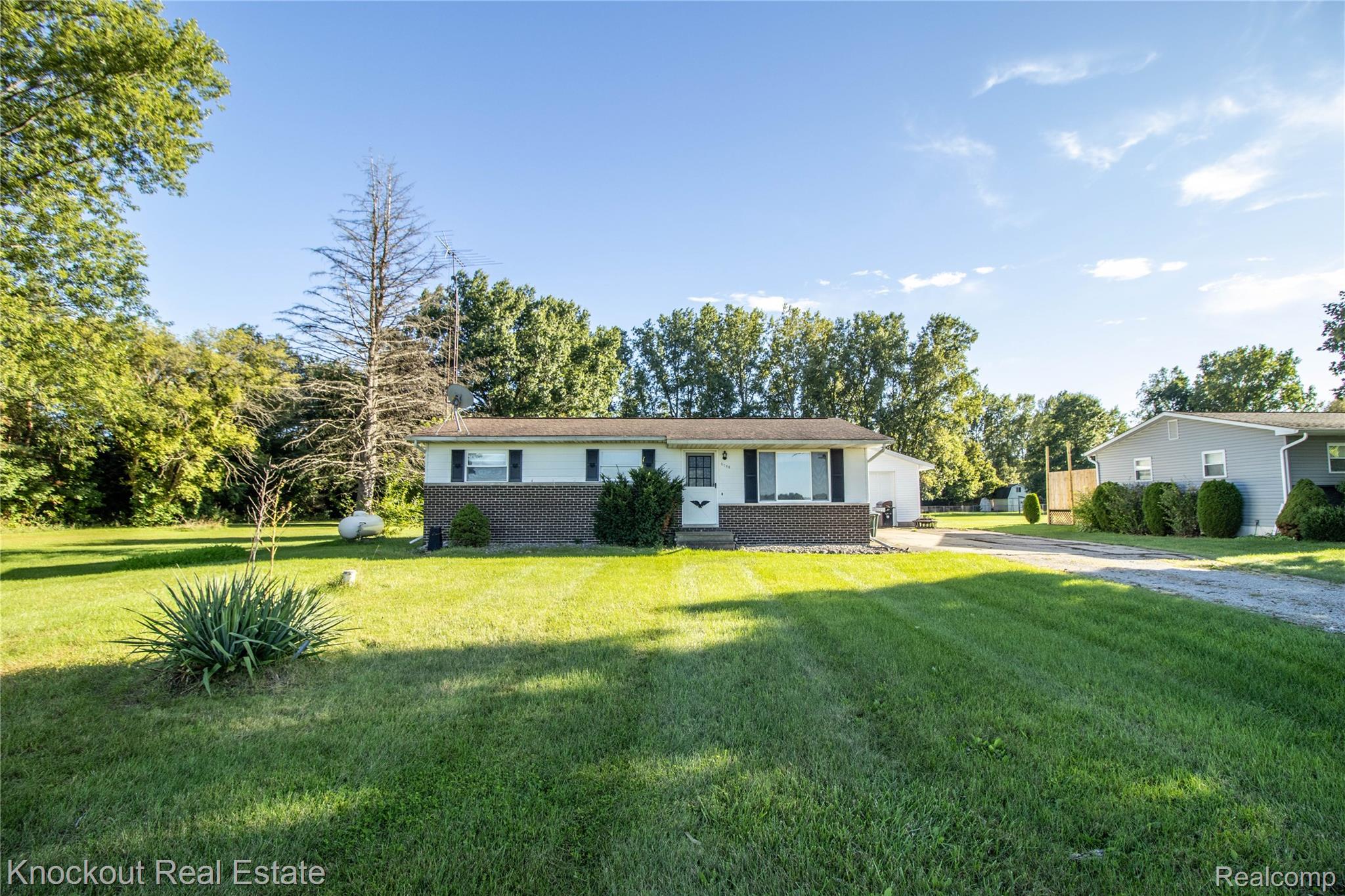 5796 East Burt Road Birch Run, MI 48415 - Photo 36 of 41 Single-story residence featuring a brick facade with light siding, a gabled roof, and a front entry