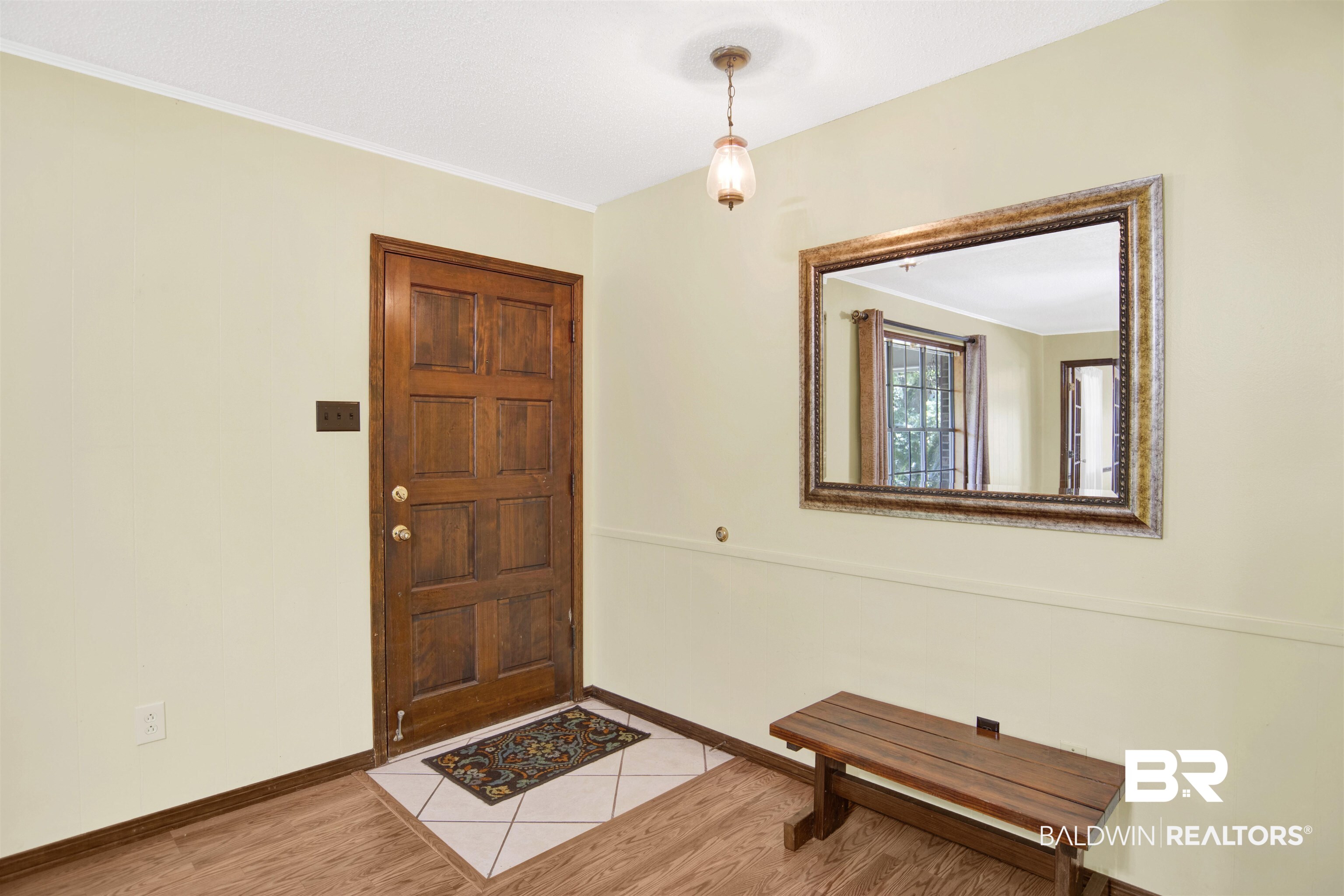 30888 Cemetery Road Daphne, AL 36527 - Photo 34 of 36 Entryway featuring a paneled wood door, light wood-finish flooring, and a white tile inlay