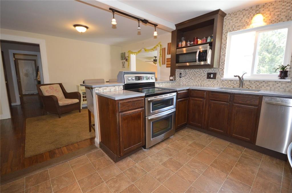 Breakfast bar easily seats four and the flow to the dining room and family room is great for entertaining.  Beautiful view from kitchen to deck and large backyard.
