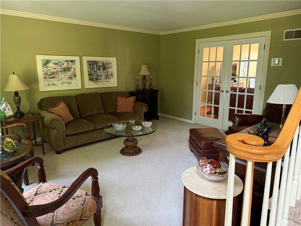 4114 Rochelle Drive Allentown, PA 18104 - Photo 21 of 35 French doors open into a refined living space with plush carpeting and elegant crown molding.