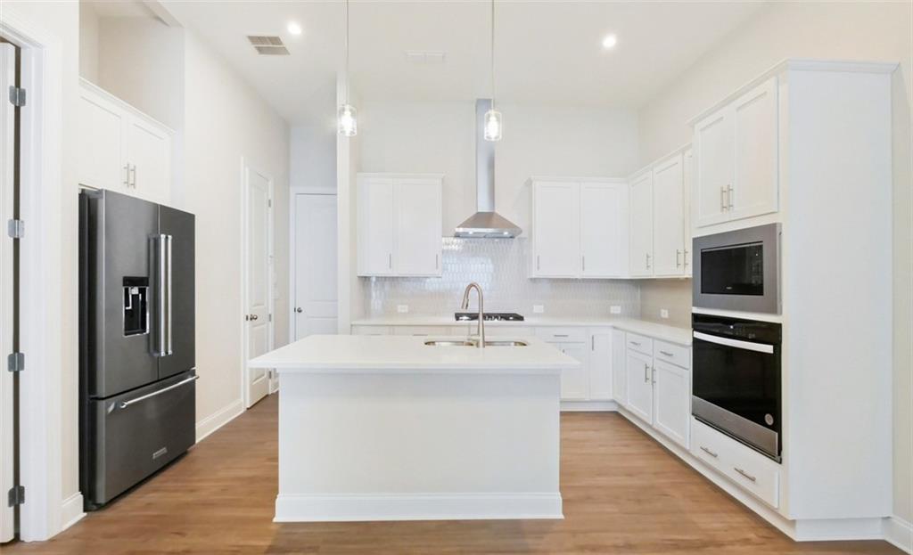726 Stickley Oak Way Woodstock, GA 30189 - Photo 13 of 40 a kitchen with stainless steel appliances a refrigerator sink and stove