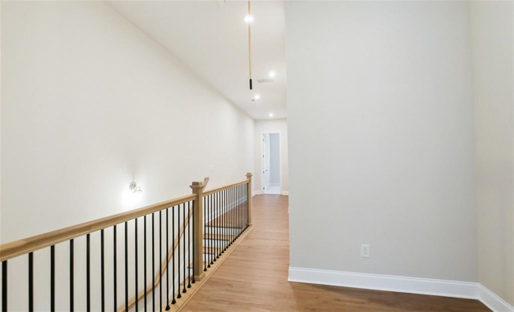 726 Stickley Oak Way Woodstock, GA 30189 - Photo 15 of 40 a view of a hallway with wooden floor