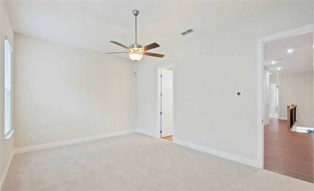 726 Stickley Oak Way Woodstock, GA 30189 - Photo 20 of 40 en empty room with a ceiling fan and a shower