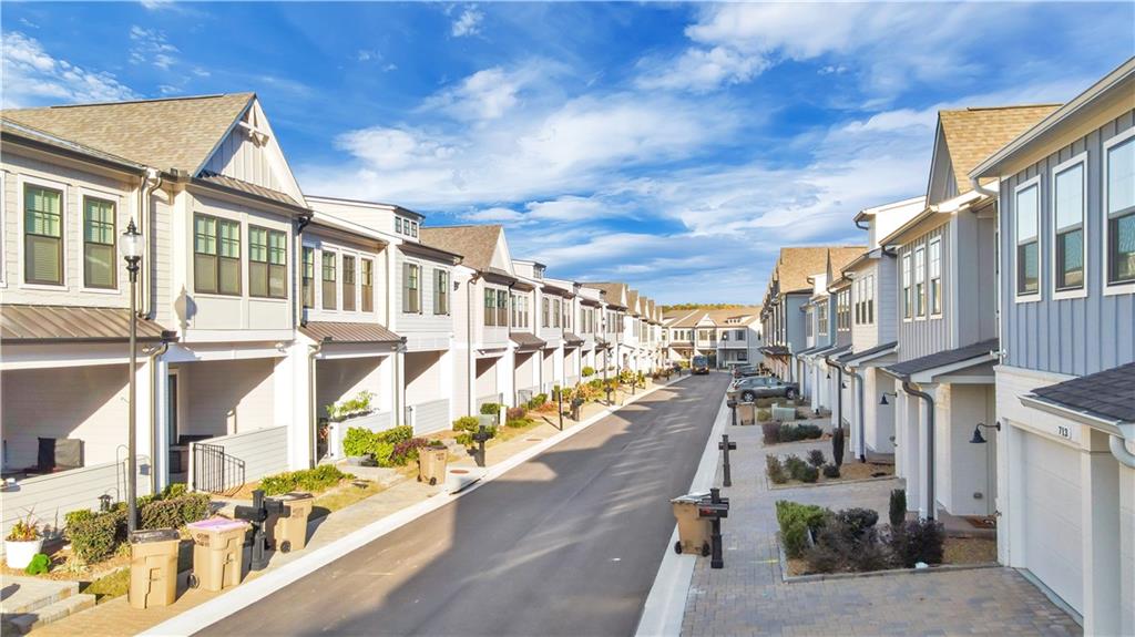 726 Stickley Oak Way Woodstock, GA 30189 - Photo 2 of 40 a city street lined with tall buildings