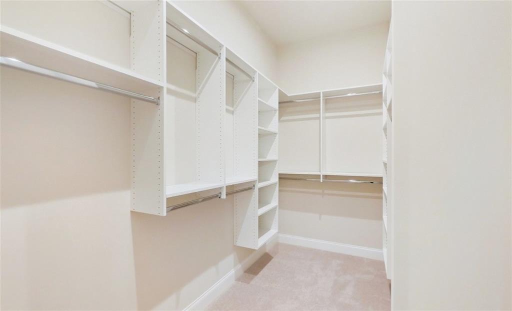 726 Stickley Oak Way Woodstock, GA 30189 - Photo 24 of 40 a view of walk in closet with empty racks
