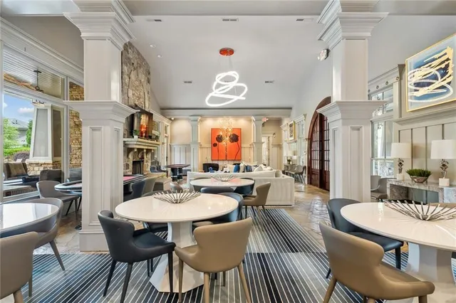 a room with pool table and windows