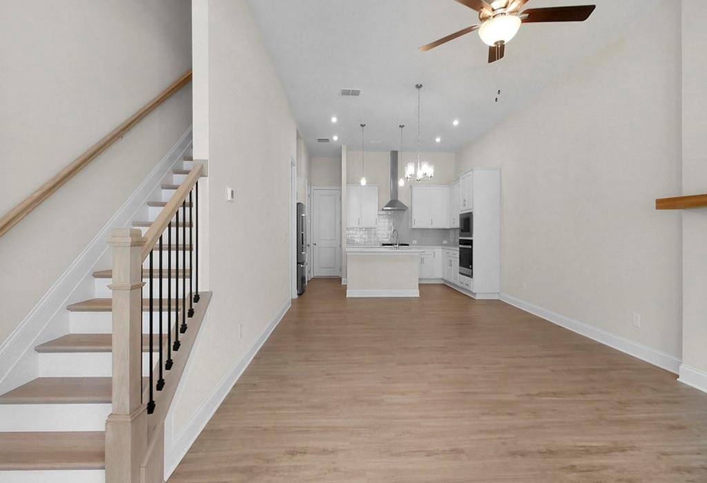 726 Stickley Oak Way Woodstock, GA 30189 - Photo 9 of 40 wooden floor in an empty room with a kitchen