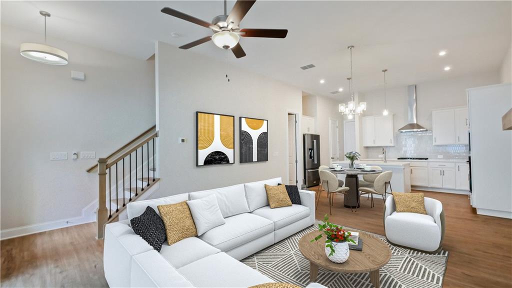 726 Stickley Oak Way Woodstock, GA 30189 - Photo 10 of 40 a living room with furniture kitchen view and a chandelier