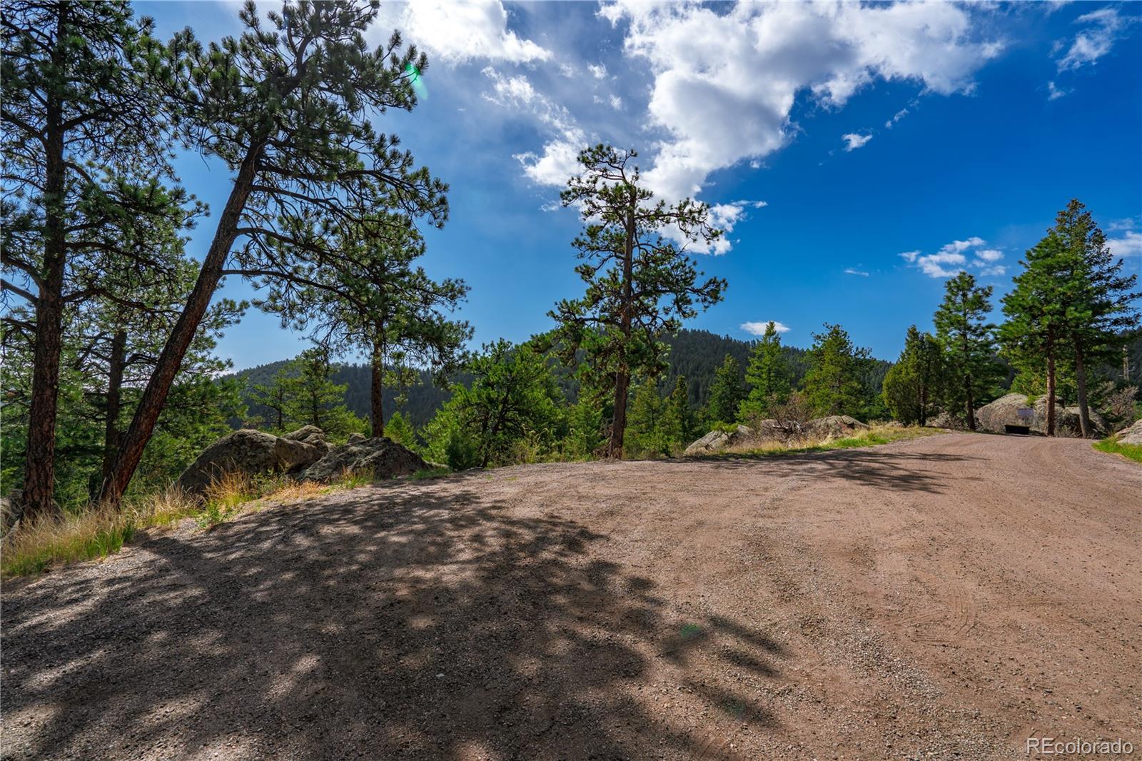 22668 Shawnee Road Indian Hills, CO 80454 - Photo 12 of 21 a view of a road with a house in the background