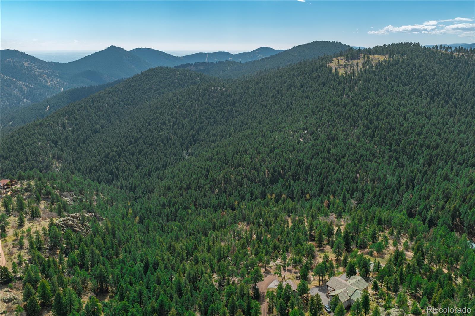 22668 Shawnee Road Indian Hills, CO 80454 - Photo 15 of 21 a view of a mountain range with lush green forest