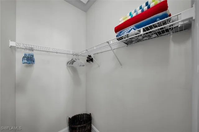 a bathroom with a bathtub shower sink vanity mirror and toilet