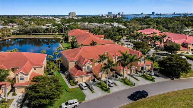 an aerial view of a house with a garden and lake view