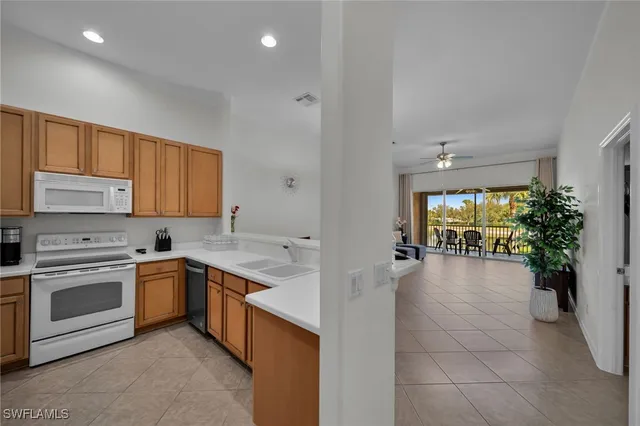 a kitchen with a stove sink and cabinets