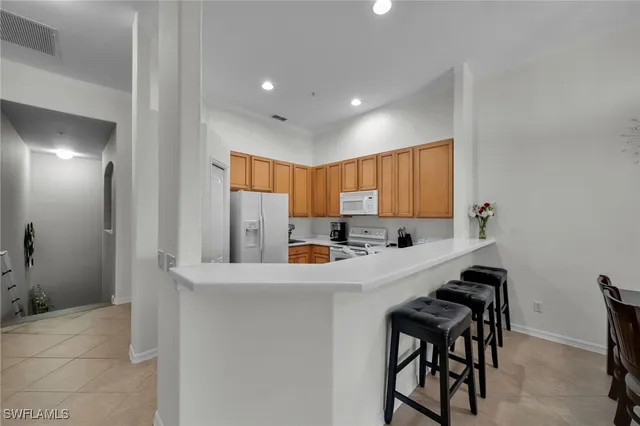 a kitchen with stainless steel appliances a sink stove and refrigerator