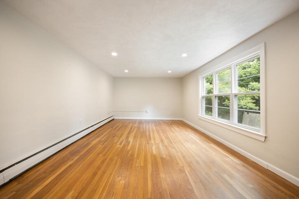 7 Riverview Avenue Maynard, MA 01754 - Photo 19 of 35 a view of empty room with wooden floor and fan