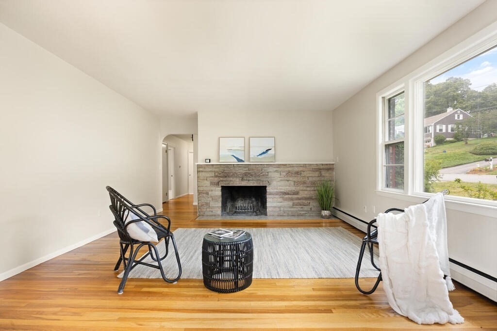 7 Riverview Avenue Maynard, MA 01754 - Photo 4 of 35 a living room with furniture a fireplace and a floor to ceiling window