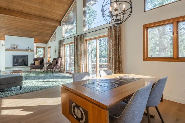 a living room with furniture fireplace and a large window
