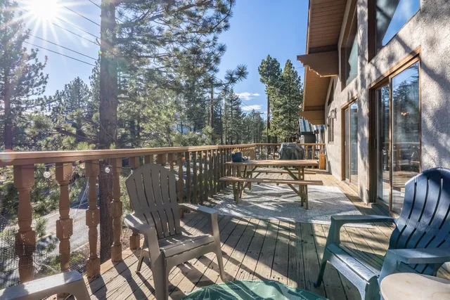 a kitchen with stainless steel appliances granite countertop a refrigerator a sink a stove a dining table and chairs