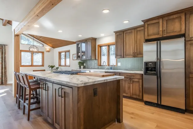 a kitchen with a stove and a wooden floors