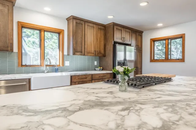 a view of a dining room with furniture wooden floor and a chandelier