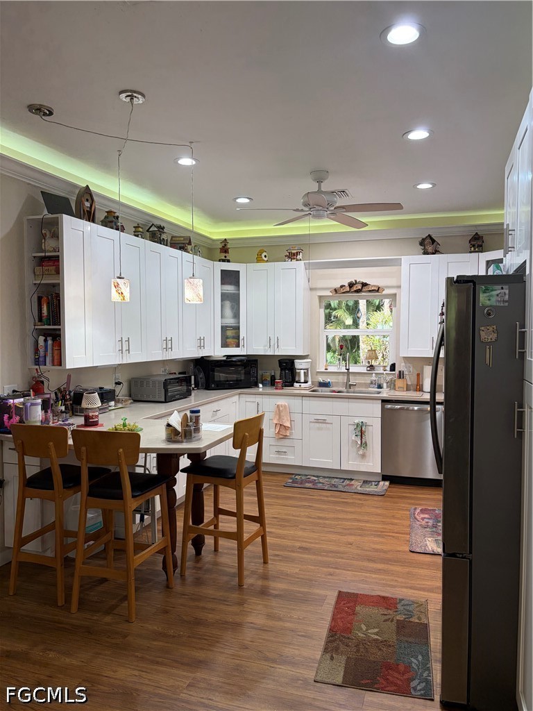 92 Evergreen Road North Fort Myers, FL 33903 - Photo 13 of 30 a kitchen with stainless steel appliances kitchen island granite countertop a table chairs and a refrigerator