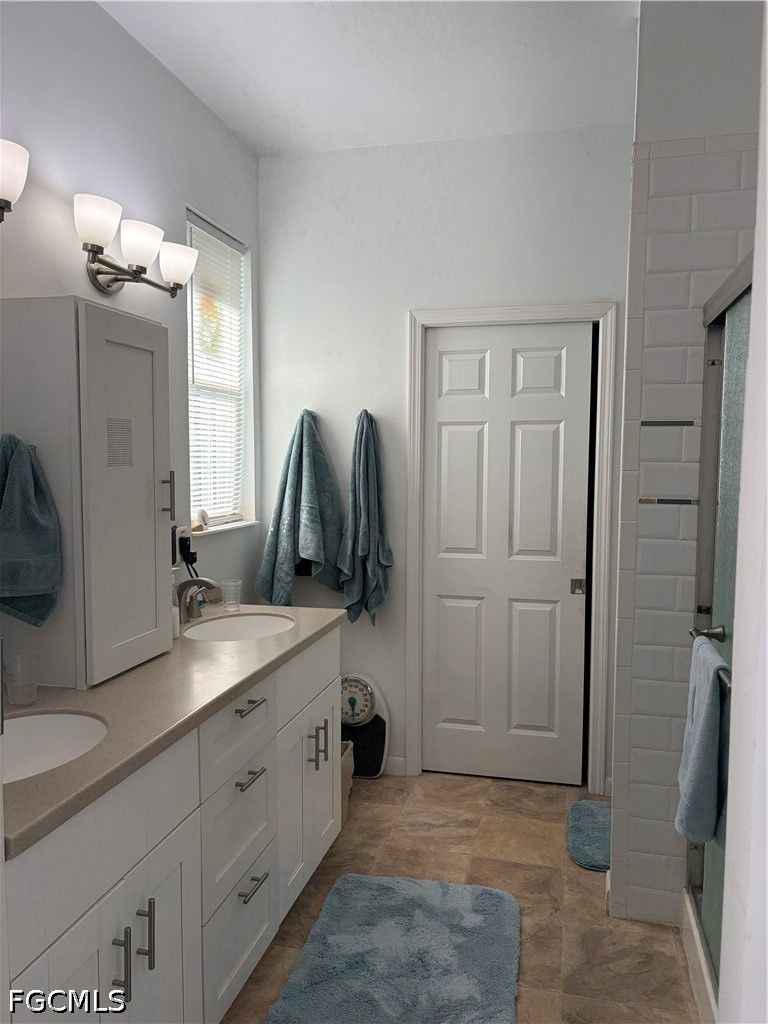 92 Evergreen Road North Fort Myers, FL 33903 - Photo 16 of 30 a bathroom with a double vanity sink and mirror