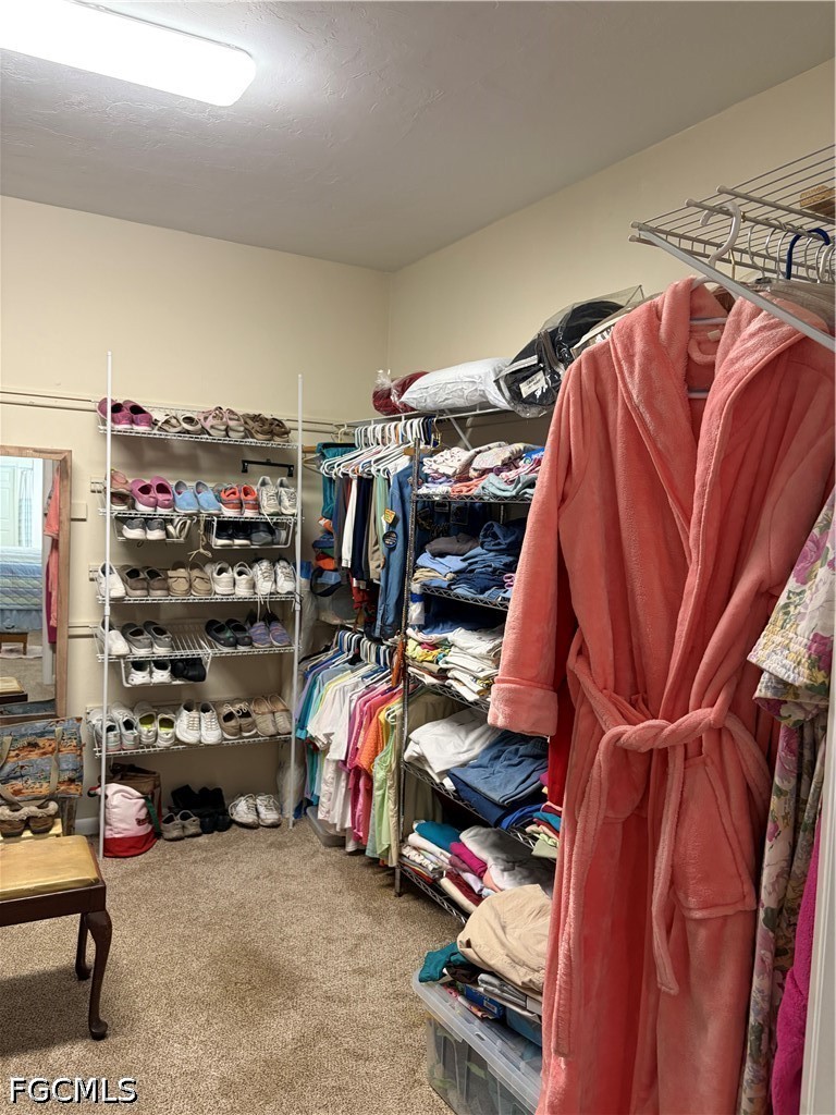 92 Evergreen Road North Fort Myers, FL 33903 - Photo 19 of 30 a view of walk in closet with clothes and shoes