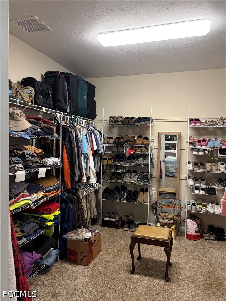 92 Evergreen Road North Fort Myers, FL 33903 - Photo 20 of 30 a view of walk in closet with clothes and shoes