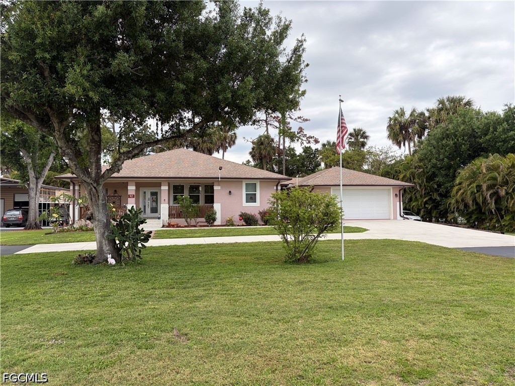92 Evergreen Road North Fort Myers, FL 33903 - Photo 3 of 30 a front view of a house with garden