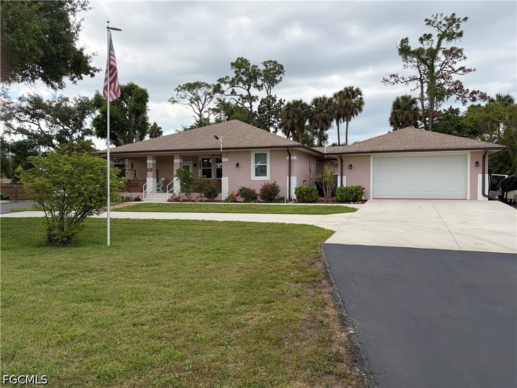 92 Evergreen Road North Fort Myers, FL 33903 - Photo 4 of 30 a front view of a house with a garden