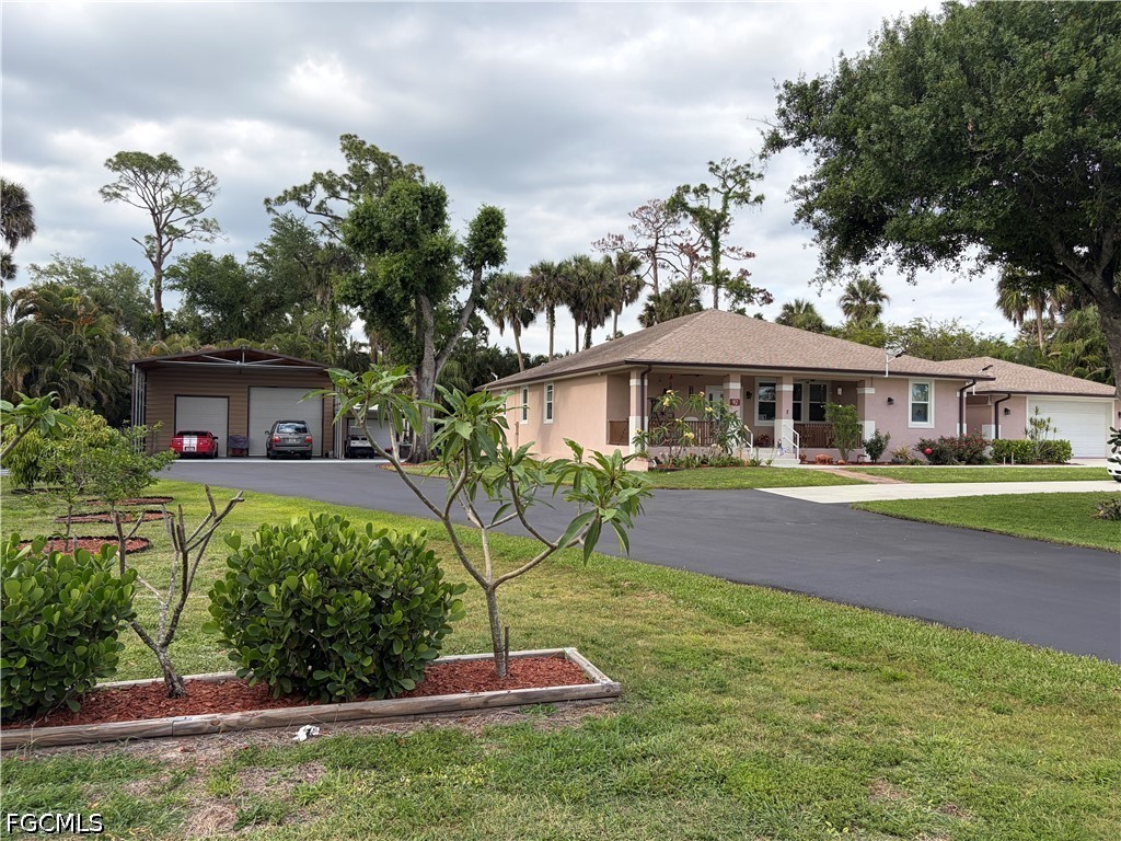 92 Evergreen Road North Fort Myers, FL 33903 - Photo 6 of 30 a front view of a house with a yard
