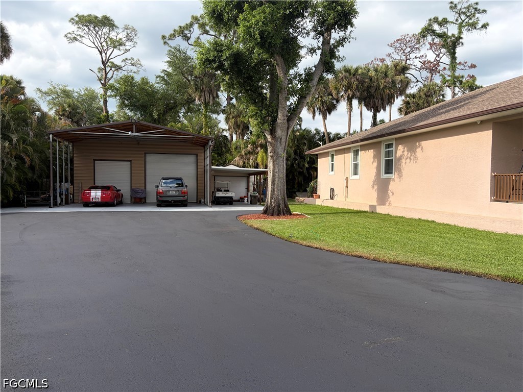 92 Evergreen Road North Fort Myers, FL 33903 - Photo 7 of 30 a view of a house with a yard and garage
