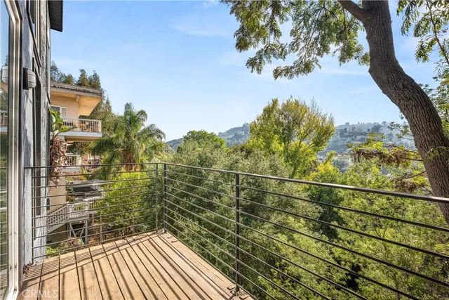 a view of a balcony with a tree