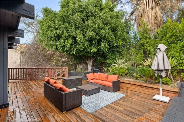 a outdoor sitting area with furniture and wooden floor