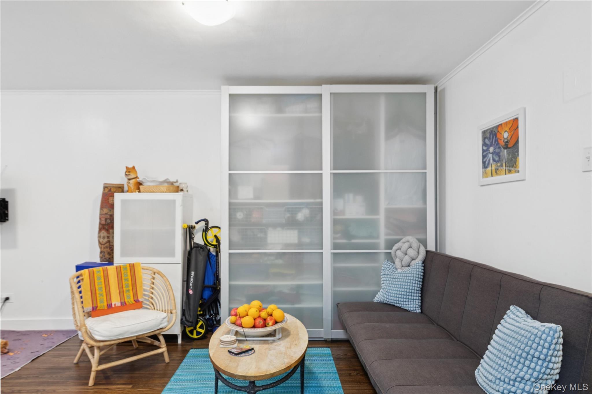 75-02 Austin Street, Unit 2C Queens, NY 11375 - Photo 2 of 6 a living room with furniture and a wooden floor