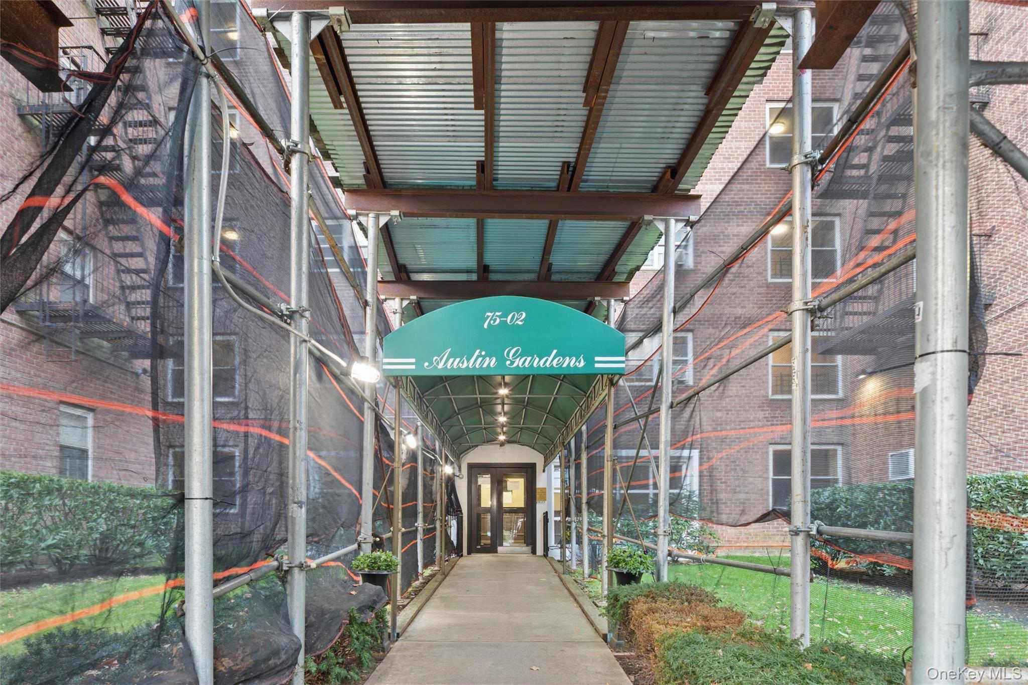 75-02 Austin Street, Unit 2C Queens, NY 11375 - Photo 6 of 6 a front view of a building with a porch