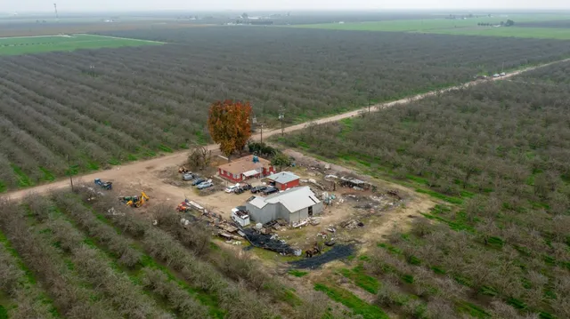 an aerial view of a house with a yard