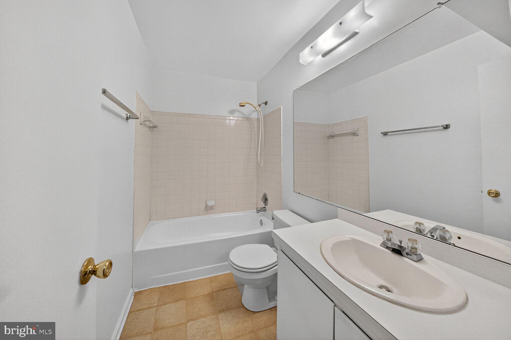 14901 McKisson Court, Unit 7CC Silver Spring, MD 20906 - Photo 17 of 34 a bathroom with a toilet sink a mirror and bathtub