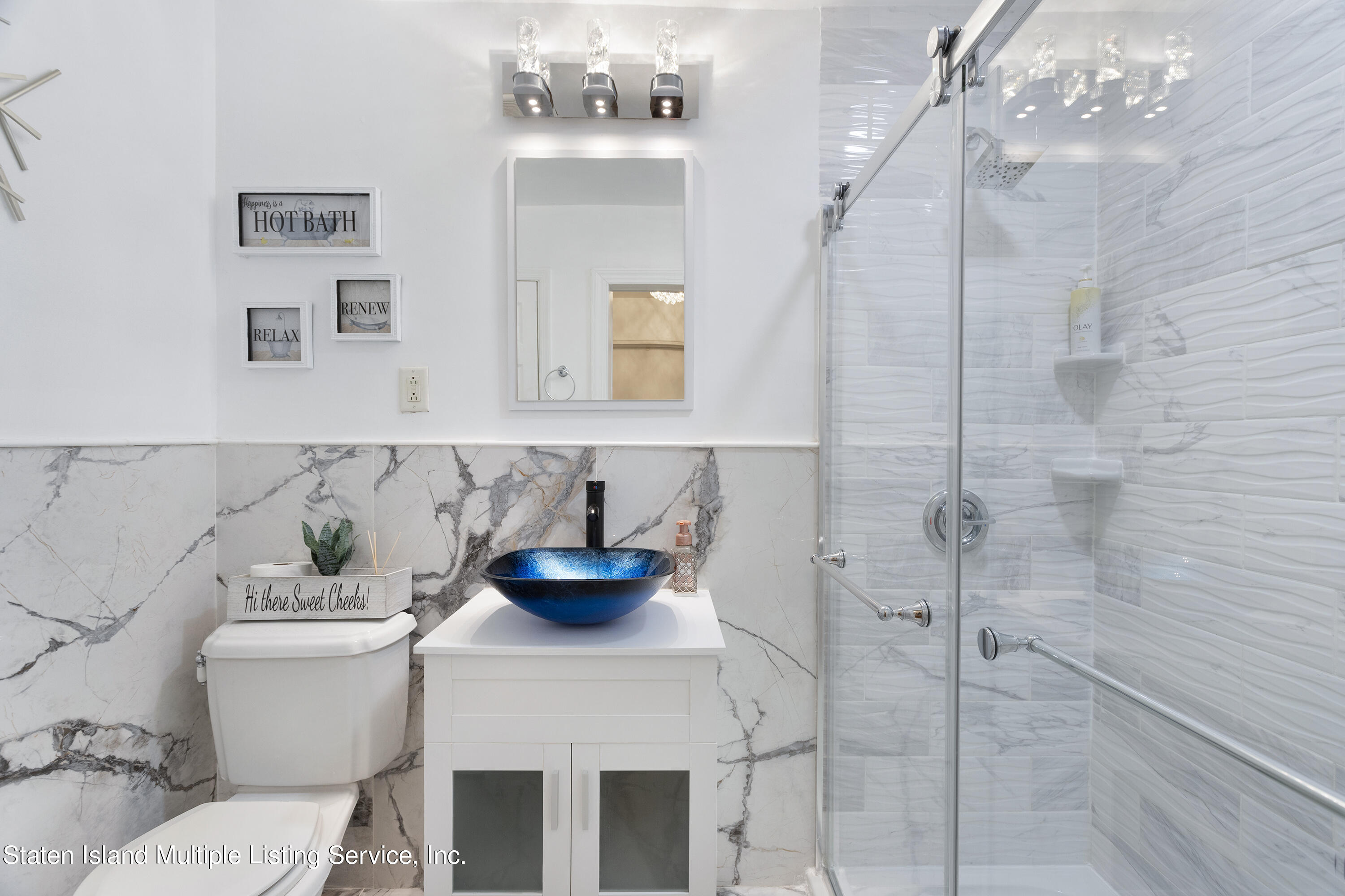 403-1 Willow Road East, Unit 1 Staten Island, NY 10314 - Photo 11 of 14 a bathroom with a sink a mirror and a toilet