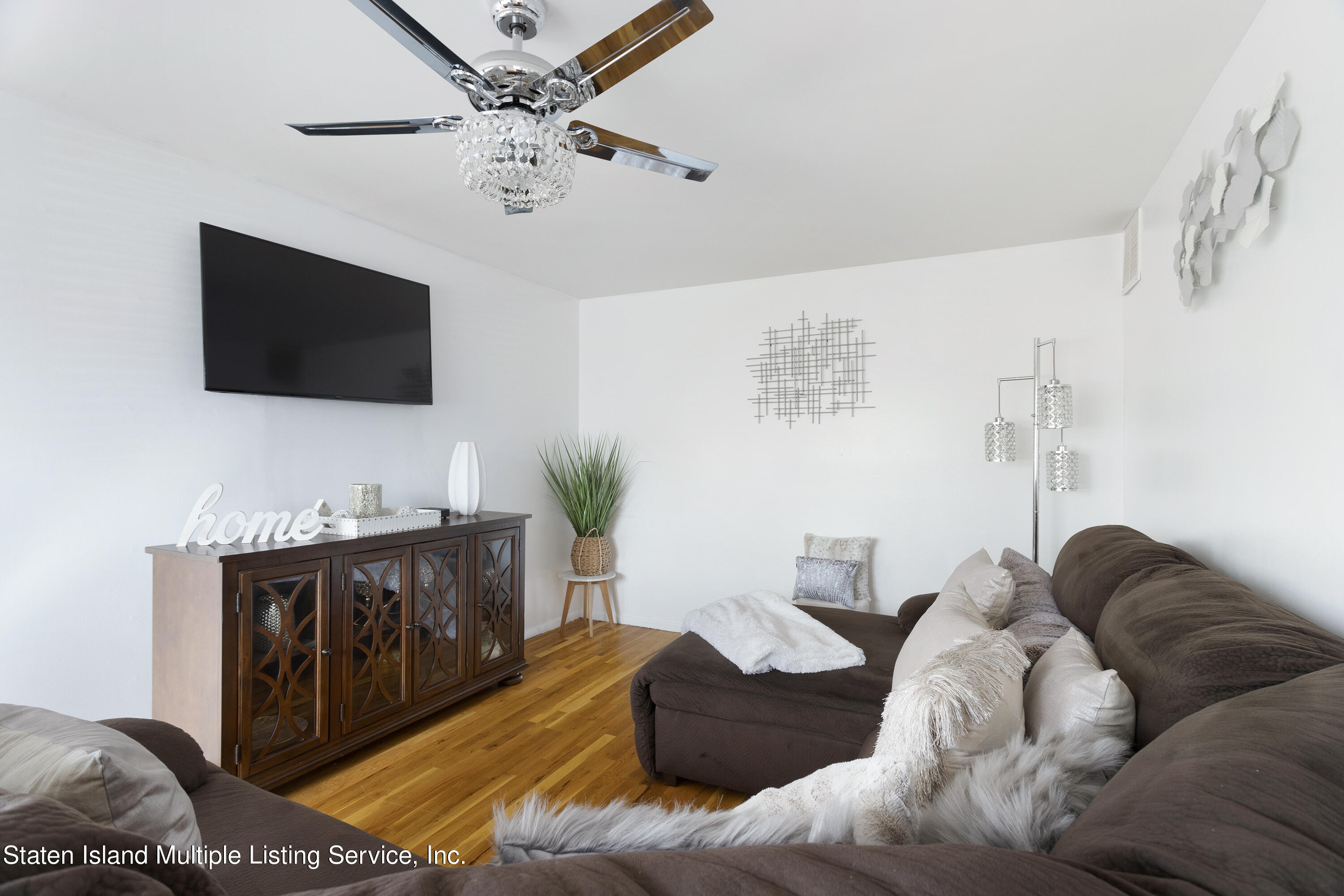 403-1 Willow Road East, Unit 1 Staten Island, NY 10314 - Photo 3 of 14 a living room with furniture and a flat screen tv