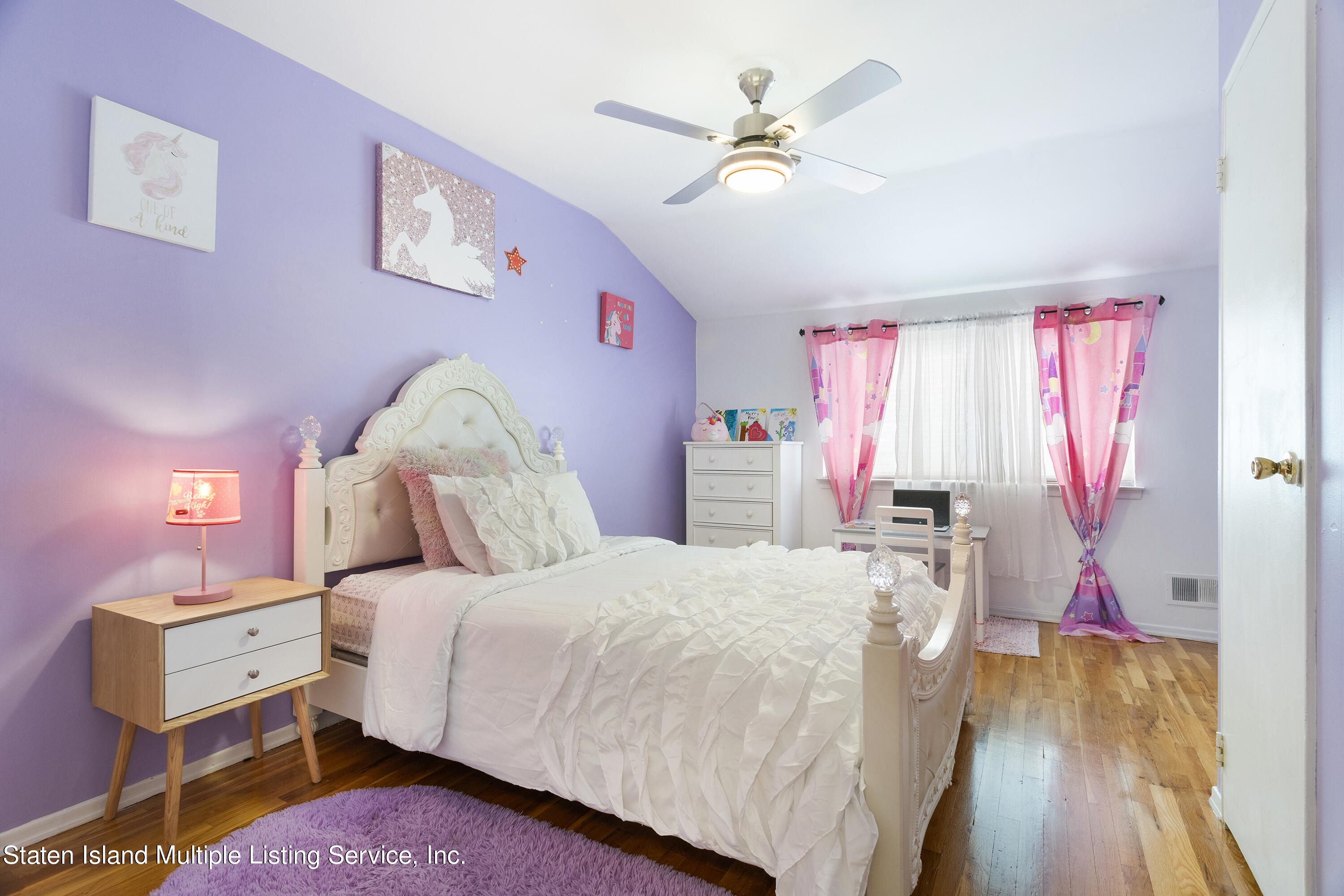 403-1 Willow Road East, Unit 1 Staten Island, NY 10314 - Photo 6 of 14 a bed room with a bed and a window