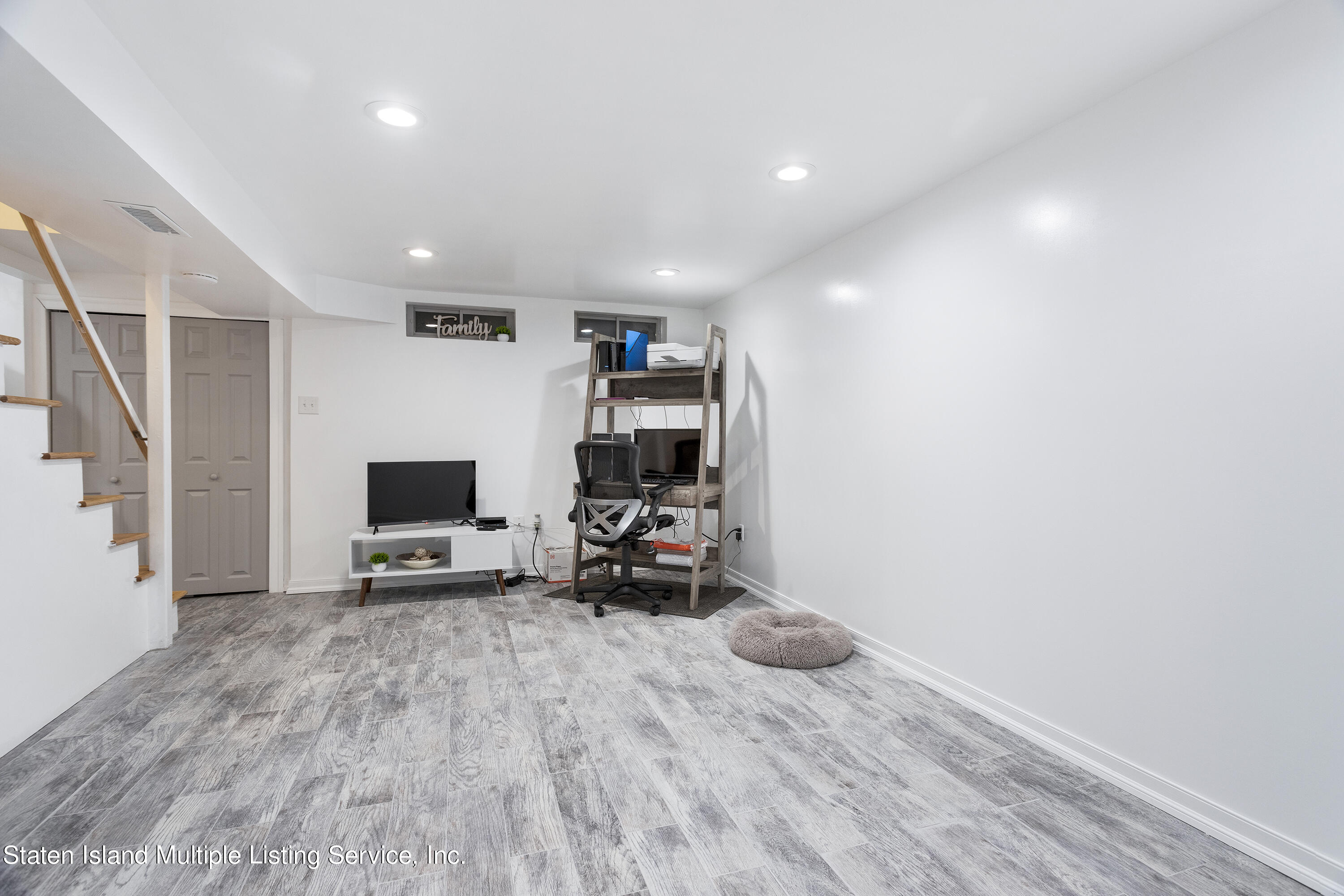 403-1 Willow Road East, Unit 1 Staten Island, NY 10314 - Photo 8 of 14 a living room with furniture and a flat screen tv
