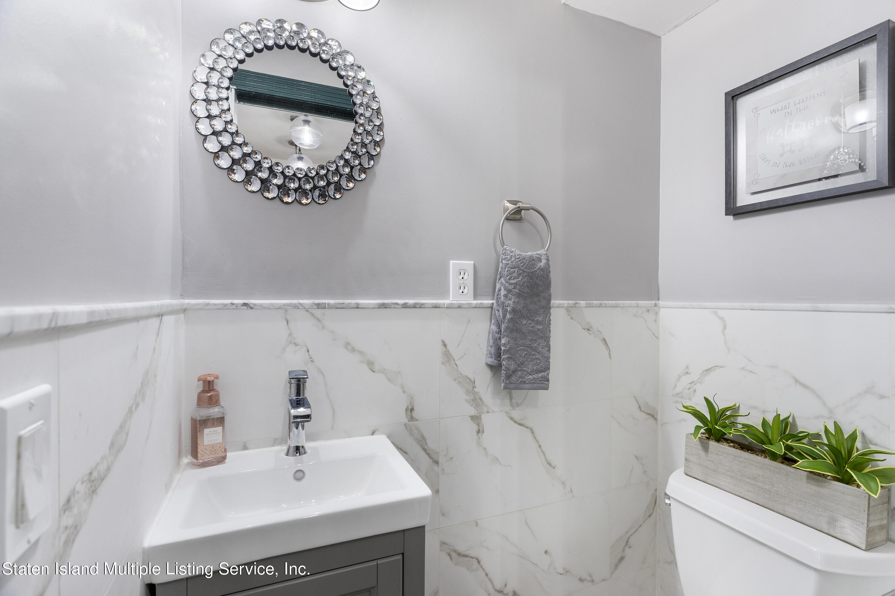 403-1 Willow Road East, Unit 1 Staten Island, NY 10314 - Photo 10 of 14 a bathroom with a sink and a mirror