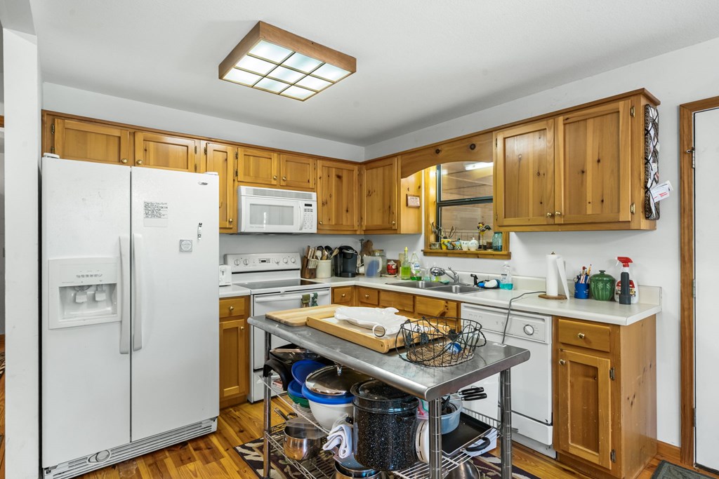 1628 Woods Valley Road Young Harris, GA 30582 - Photo 11 of 36 a kitchen with a sink a stove and a refrigerator