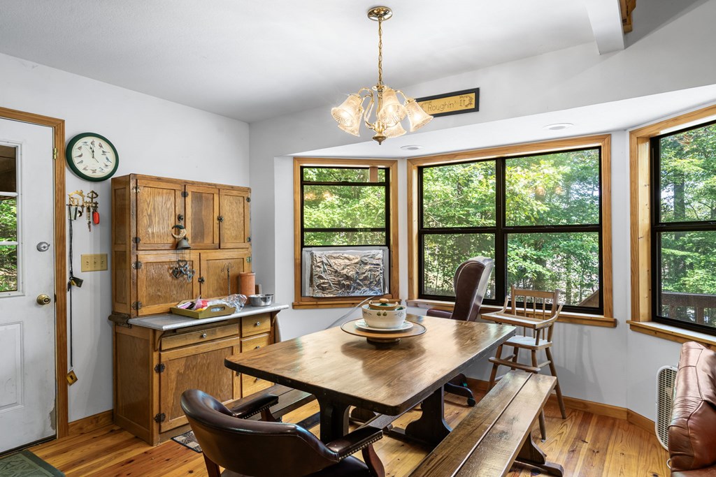 1628 Woods Valley Road Young Harris, GA 30582 - Photo 12 of 36 a view of a dining room with furniture window and outside view