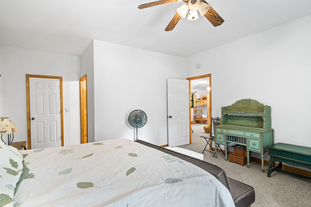 1628 Woods Valley Road Young Harris, GA 30582 - Photo 15 of 36 a bedroom with a bed and a chandelier