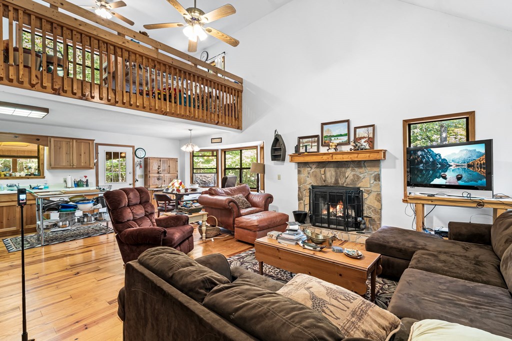 1628 Woods Valley Road Young Harris, GA 30582 - Photo 5 of 36 a living room with furniture a fireplace and a flat screen tv